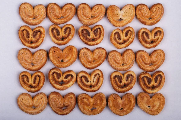 group of sugar cookies in the shape of a heart on a light backgroun