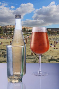 Tenerife İspanyol adasında sıcak bir yaz plajıarka planda ferahlatıcı limonata ve meyve suyu bir şişe