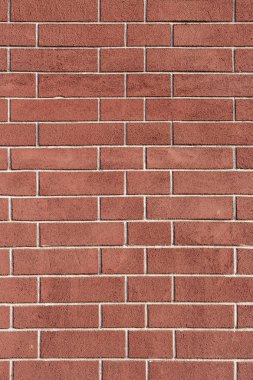 Düzenli geometrik yapıya sahip kırmızı tuğla duvar