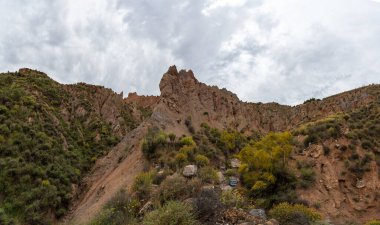 Güney İspanya 'nın dağlık arazisi, dağlar aşırı derecede aşınmış, yarı çöl bölgesi, taşlar ve çalılar var ve gökyüzü bulutlu.
