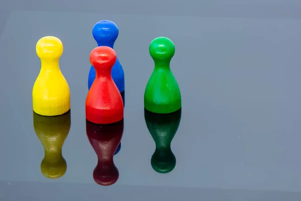 Different leisure game pawn figures, concept for diverse group of people. Cutout, isolated on white.