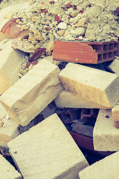 Background of building rubble with terracotta bricks and other white stone bricks very famous in Sicily. Vertical view