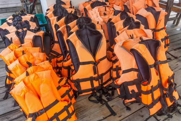 Group of orange life jacket on boat