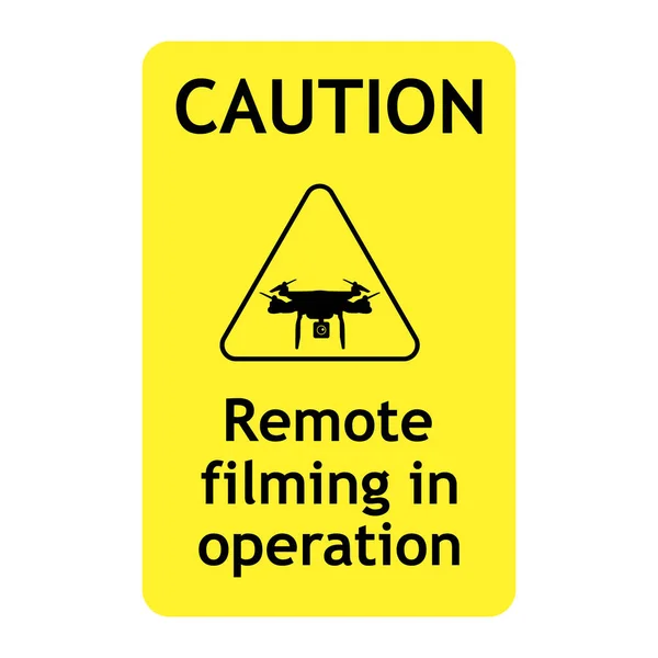 Caution remote filming in operation yellow warning sign