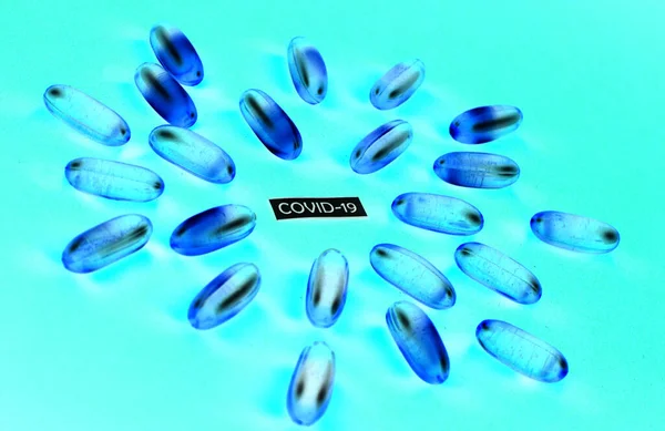 blue pills on a blue background, covid-19