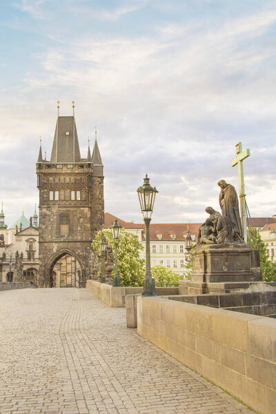 Beautiful view of Old Town Tower of Charles Bridge at dawn in Prague, Czech Republic