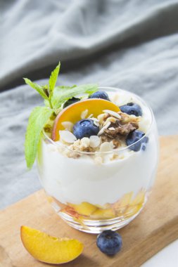 Sağlıklı yaban mersini, şeftali ve cevizli parfe.