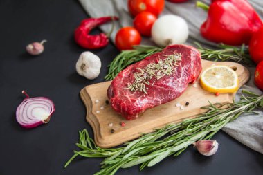 Kesme tahtasında baharatlı çiğ biftek. Yaratıcı atmosfer dekorasyonu