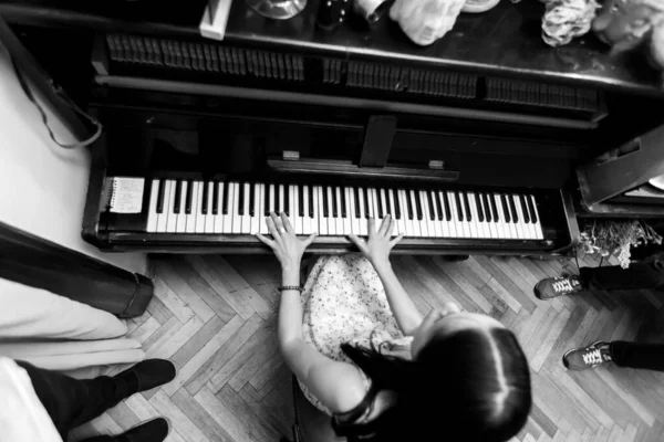 Girl playing the piano, top view