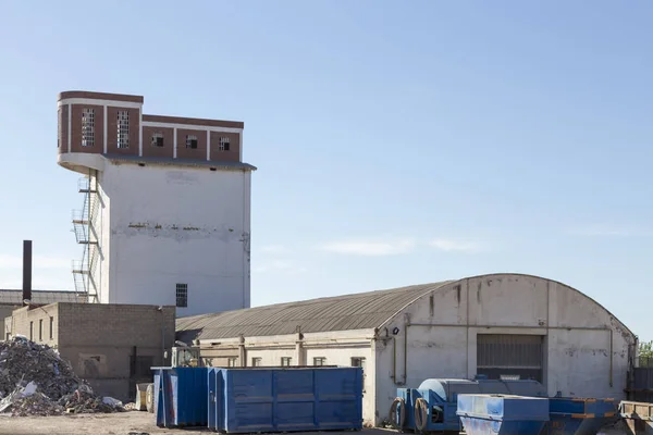 Curious industrial installation composed of several warehouses and a building without windows topped with another building added at the top, Sagunto, Valencia, Spain