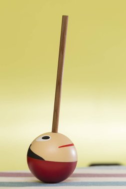 infant pencil sharpener in the shape of a ball painted face and an introductory pencil making a nose clipart