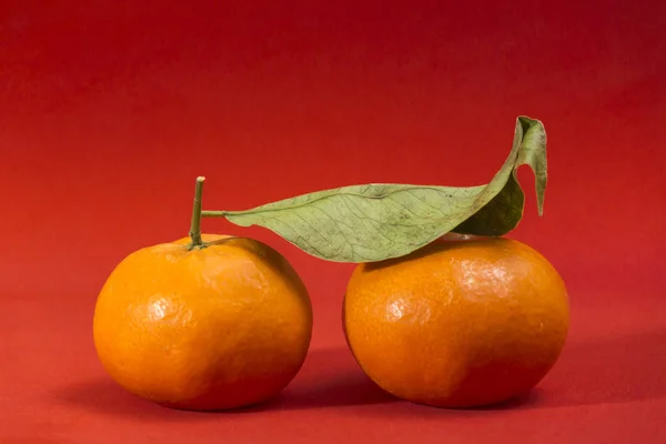 Zwei Mandarinen Eine Mit Blattaufstrich Beide Auf Rotem Hintergrund Einer — Stockfoto