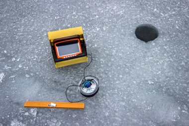 Sounder, electric device for winter fishing under the ice of the Dnieper River, Ukraine clipart