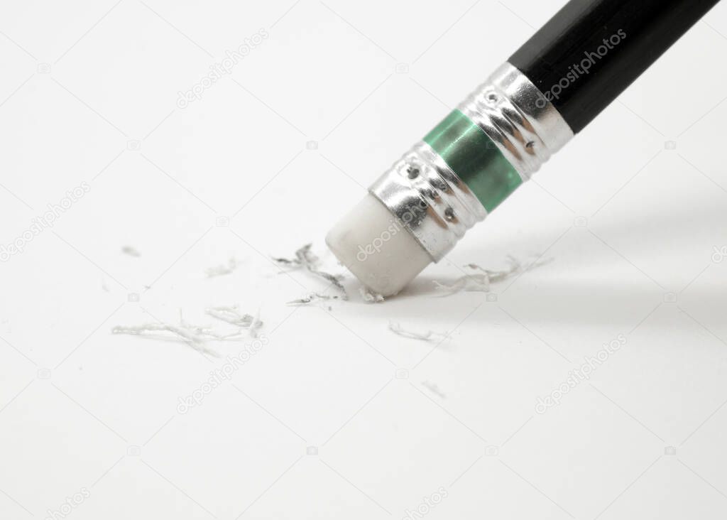 eraser removing a written mistake on a piece of paper.