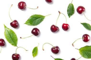 Olgun kiraz çilekleri ve kiraz yaprakları beyaz arka planda izole edilmiş.