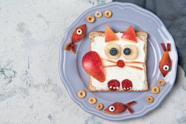 Kedi şeklinde yayılmış tost, çocuklar için yemek fikri, üst manzara.