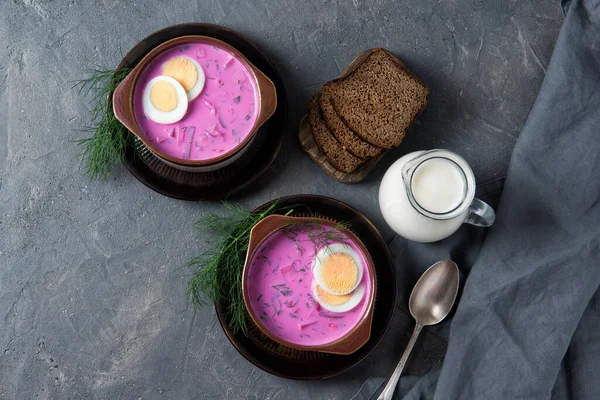 Cold beetroot soup okroshka with kefir served with boiled eggs, dill and bread slices, rustic background, top view — Stock Image Cold Beetroot Soup Okroshka Kefir Served Boiled Eggs Dill Bread Stock Picture