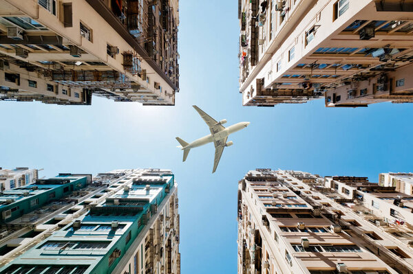 Aerial view of plane in flight over buildings