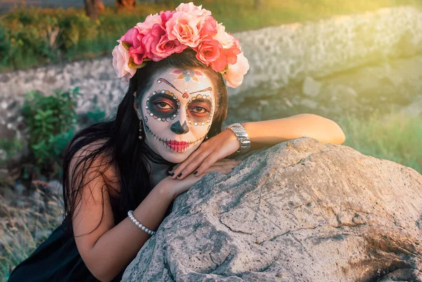 Young woman with sugar skull makeup. Day of The Dead. Halloween. Catrina portrait.