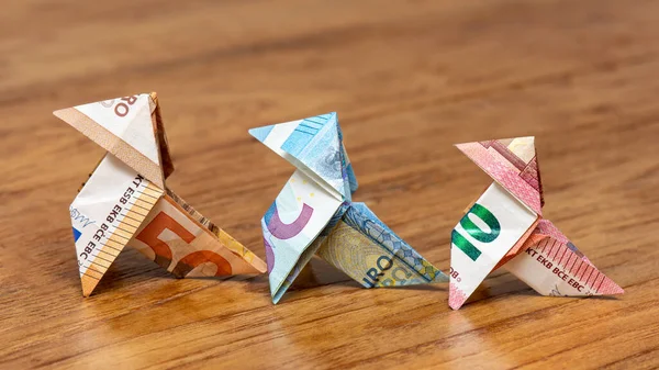 Origami birds made of 10, 20 and 50 euro bank notes