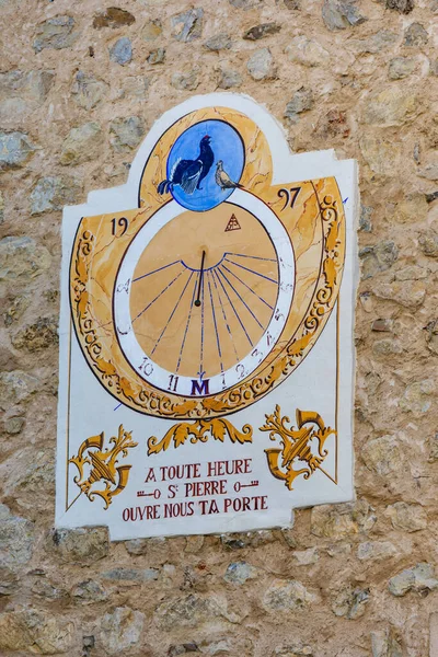 Sundial of the village of Saint-Pierre-d`Argencon, Hautes-Alpes, France, on which is written in French: `At any hour St Pierre, open your door to us`