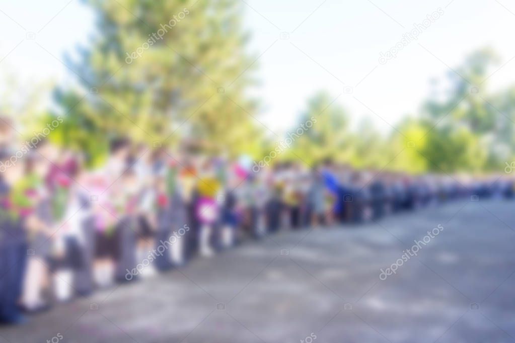 blurred abstract background image with students and teachers at the school meeting on the day of knowledge September 1