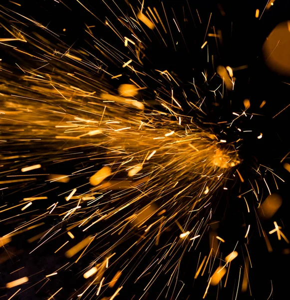 Bright yellow sparks on a black background