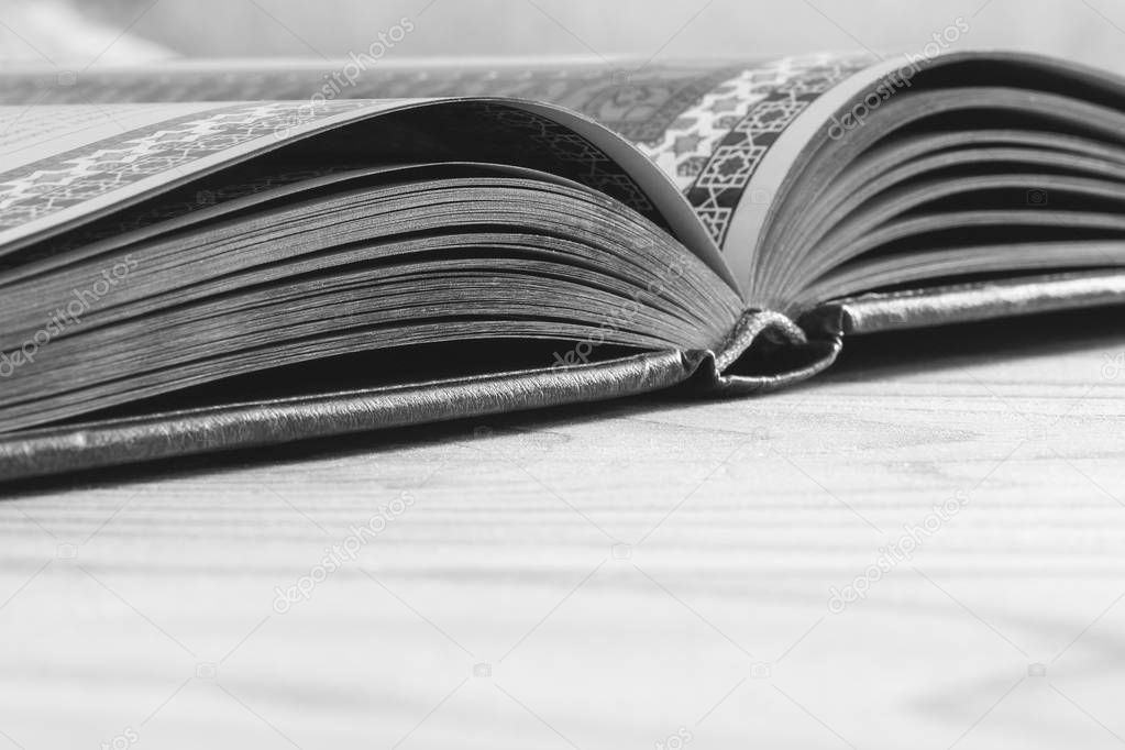 open book on the wooden table with copy space, selective focus and shallow depth of field, black white photography