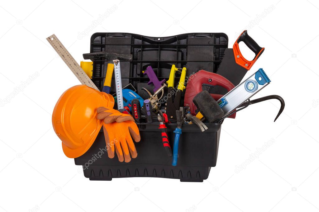 an open black plastic tool kit box with an orange construction protective helmet and various hand tools isolated on a white background close up