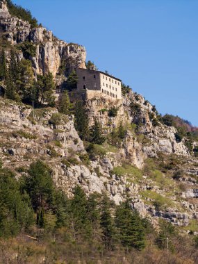Hermitage of Sant'Onofrio in Morrone perched on the mountain clipart