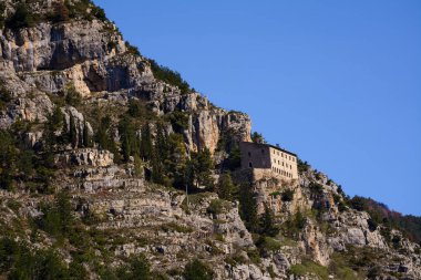 Hermitage of Sant'Onofrio in Morrone perched on the mountain clipart