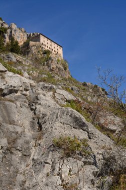Hermitage of Sant'Onofrio in Morrone perched on the mountain clipart