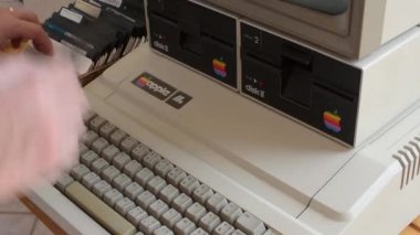 Cisternino, İtalya - 29 Nisan 2018: Yaşlı elma bilgisayar ve el disket ve klavyede yazarak değiştirme