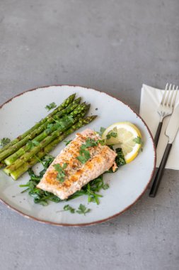 Kızarmış somon ve yeşil kuşkonmaz.