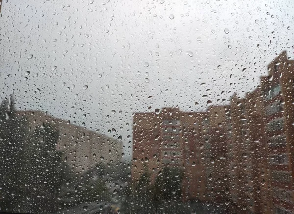 rain in the city. raindrops on the glass. rain drops on window glass
