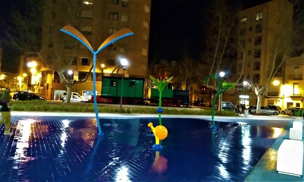 Parque y plaza de la panderola por la noche con juegos para nios en el grao de castellon, Spain.