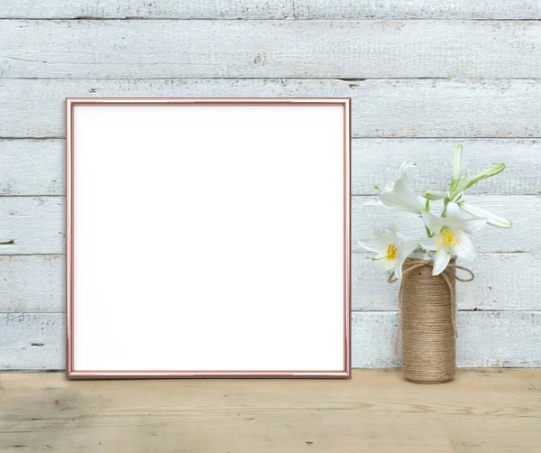 Rose Gold square Frame mockup near a bouquet of lilies stands on