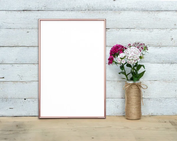 Rose Gold Vertical A4 Frame mocap near a bouquet of sweet-willia