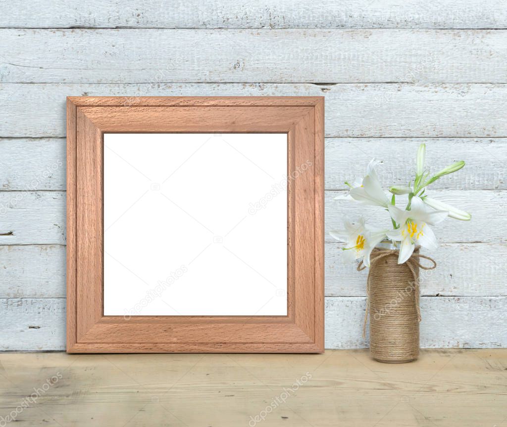 Square Old Wooden Frame mockup near a bouquet of lilies stands o