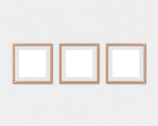 Conjunto de 3 quadros quadrados de madeira mockup com uma borda pendurada na parede. Base vazia para imagem ou texto. Renderização 3D . — Fotografia de Stock