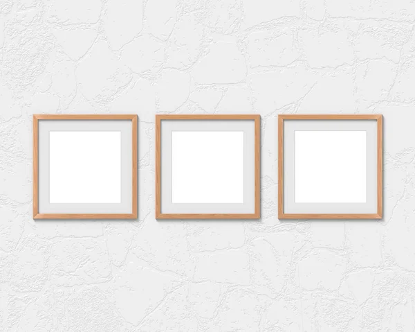 Набір з трьох квадратних дерев'яних рамок макет з бордюром, що висить на стіні. Порожня основа для зображення або тексту. 3D візуалізація . — стокове фото