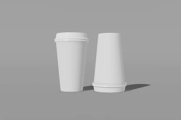 Две бумажные чашки макет с крышкой на сером фоне. Одна из чашек перевернута с ног на голову. 3D рендеринг — стоковое фото