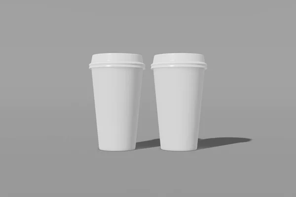 Набор из двух белых бумажных макетов чашки с крышкой на сером фоне. 3D рендеринг — стоковое фото
