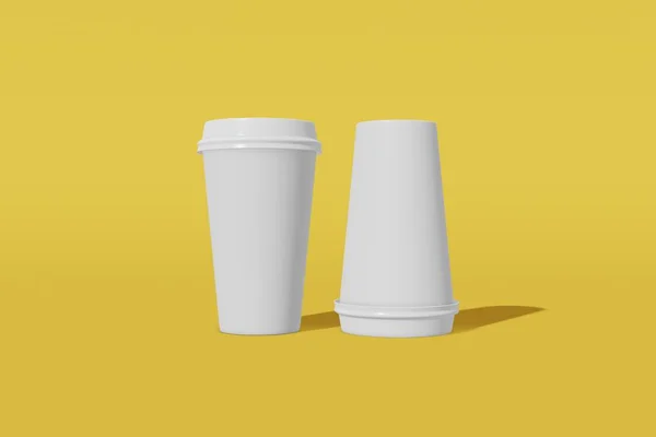 Deux tasses en papier maquette avec un couvercle sur un fond jaune. Une des tasses est retournée. rendu 3D — Photo