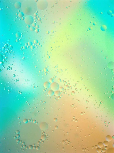 Beautiful abstract yellow green bubbles oil with sweet colorful background ,macro image ,pastel color, water droplets