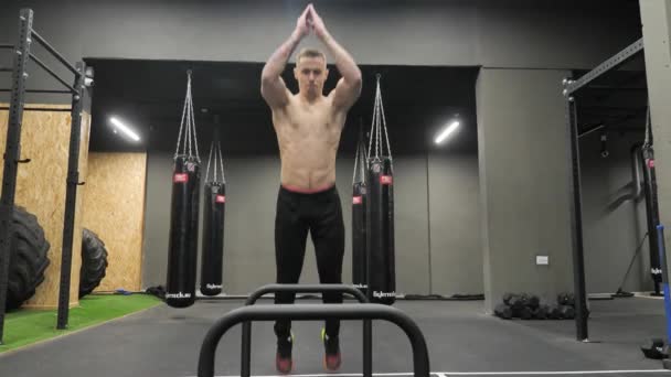 Athletic Sportsman Doing Jumping with a Squat through Barriers in CrossFit Gym — Stock Video
