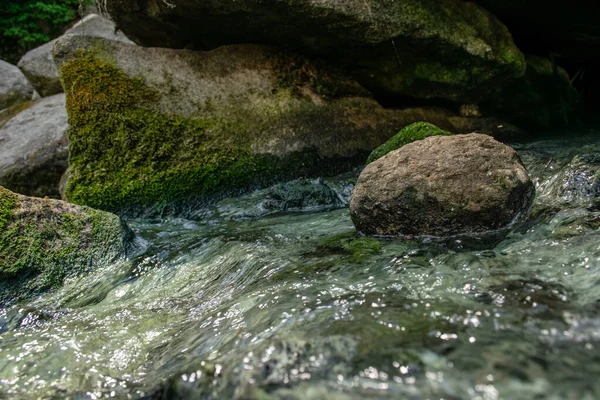 Su akışında yuvarlak nehir taşı 