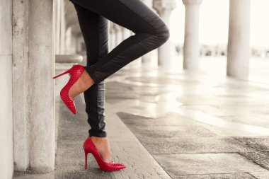 Seksi bacaklar duvar tarafından ayakta kadınla