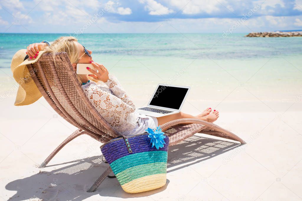 Busy business woman working on the beach