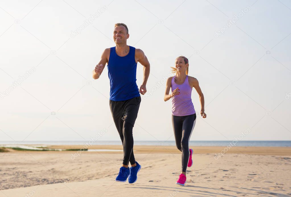 Couple working out by the sea